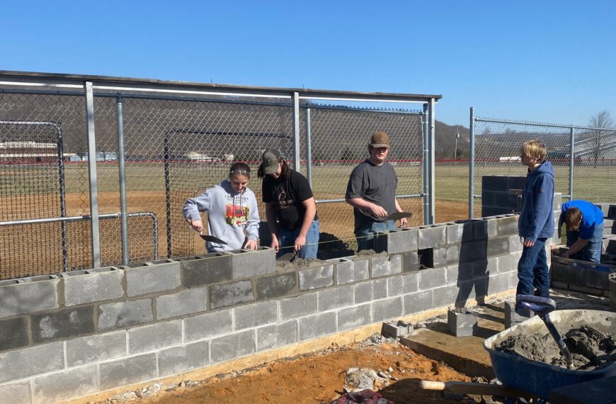 Masonry students help rebuild district dugouts