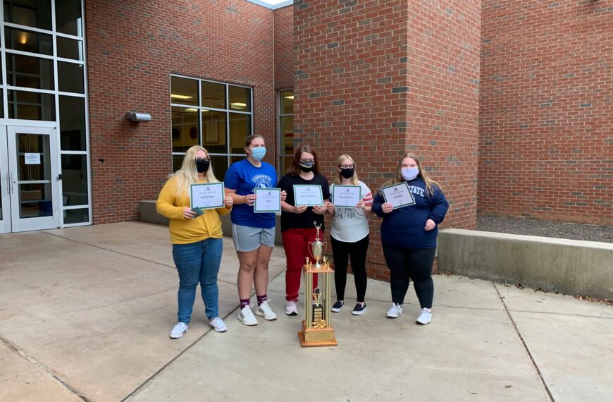 Slay the Dragon team receives trophy from last year’s win