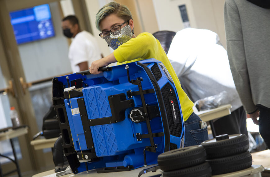 Students assemble cars for mobile-challenged preschoolers